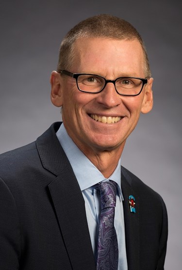 Head shot of Todd Penegor in a suit and tie