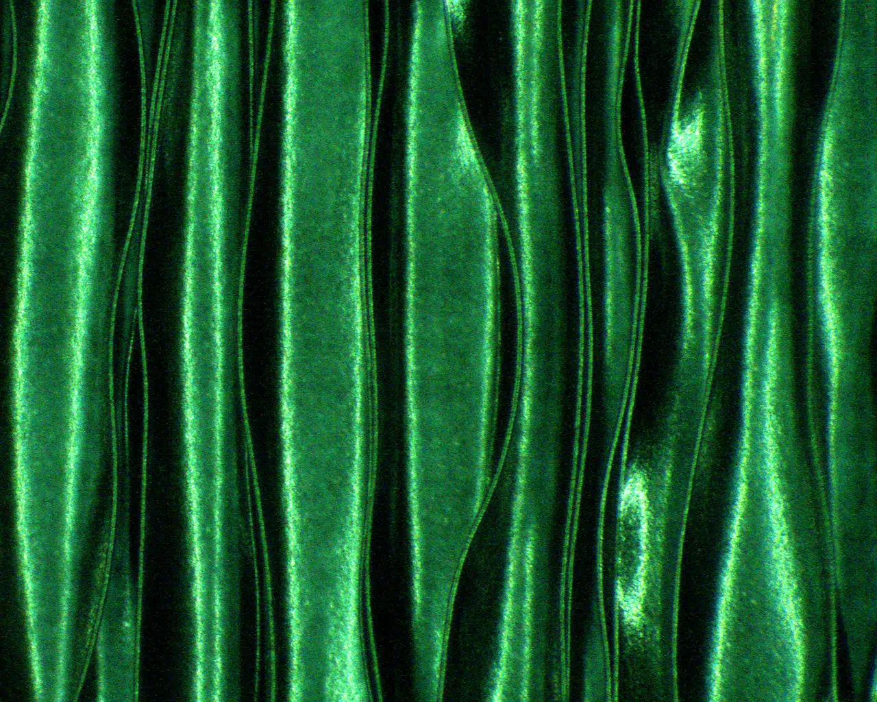 An optical microscope image shows what looks like a wavy green fabric but is actually a “wrinkly” electrode that could help power flexible electronics.