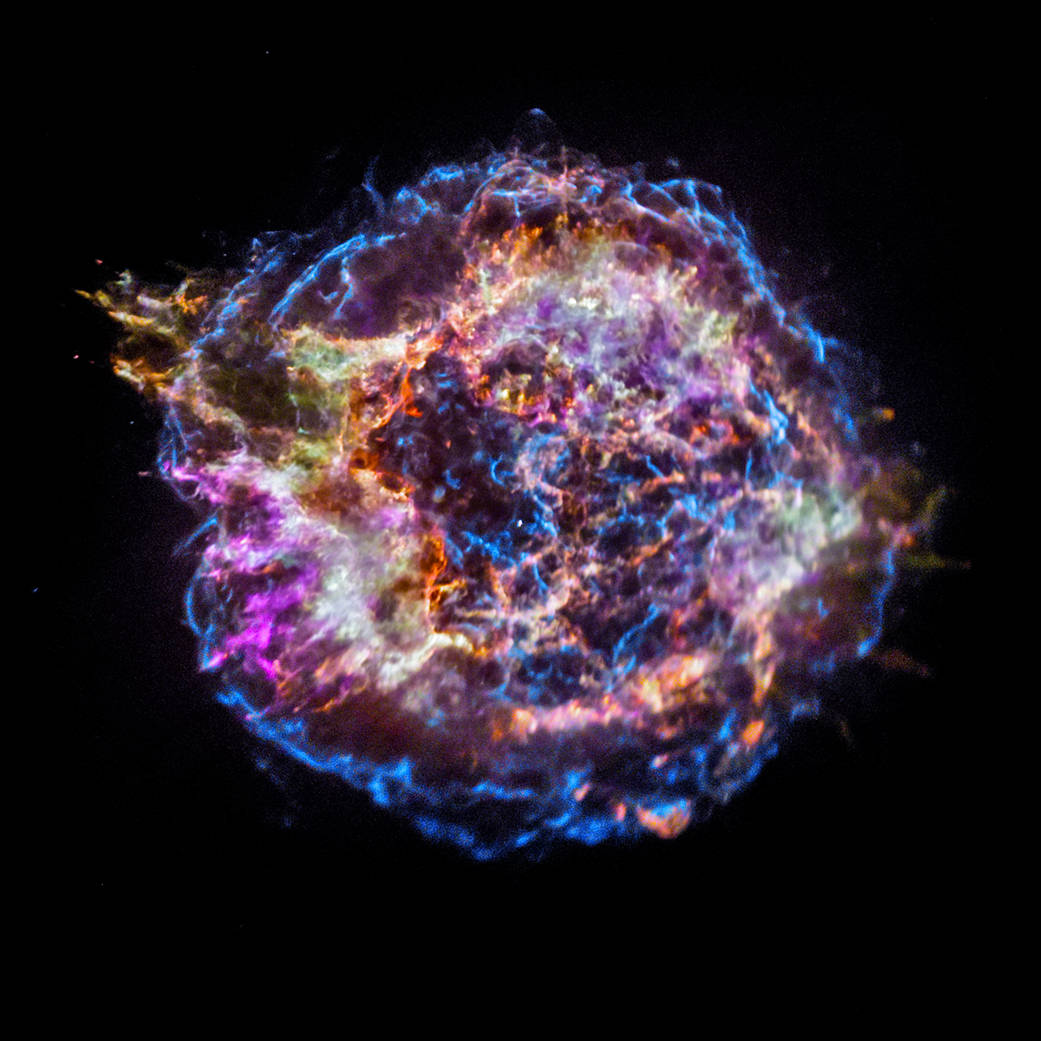 The remnants of an exploded star, or supernova, known as Cassiopeia A shown in a burst of orange, blue and purple by NASA's Chandra X-ray Observatory