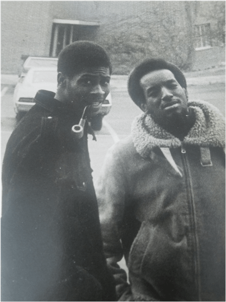 Black and white photo with Moore, on the right, standing with fraternity brother outside Holden Hall, 1973.