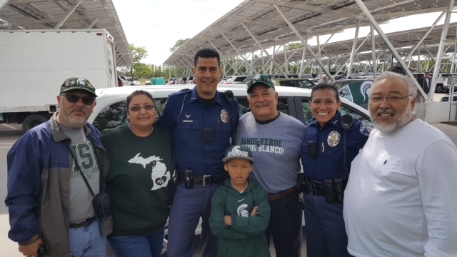 Officer Sherief Fadly posing with family and friends at MSU stadium.