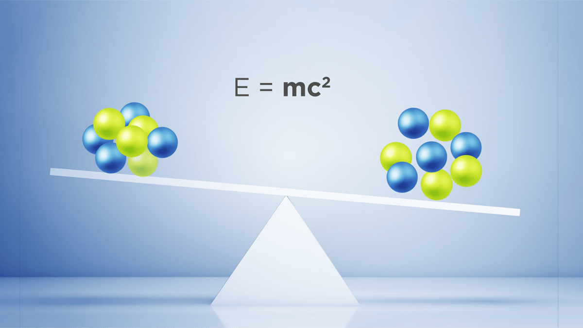 An illustration shows two zirconium nuclei on a seesaw-like balance. Both nuclei have 40 protons and neutrons, represented by green and blue orbs, but the one on the right is loosely-packed and heavier than the more tightly-bound version on the left.
