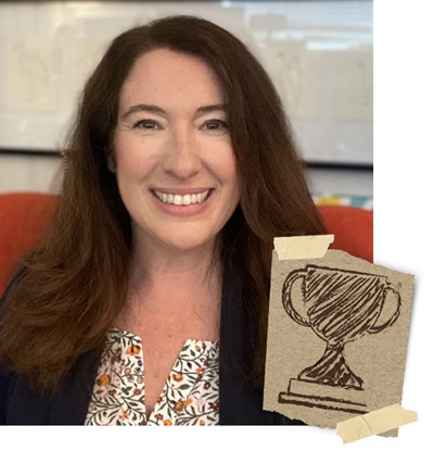 Michele Brock, with an image of a trophy drawn on brown paper 