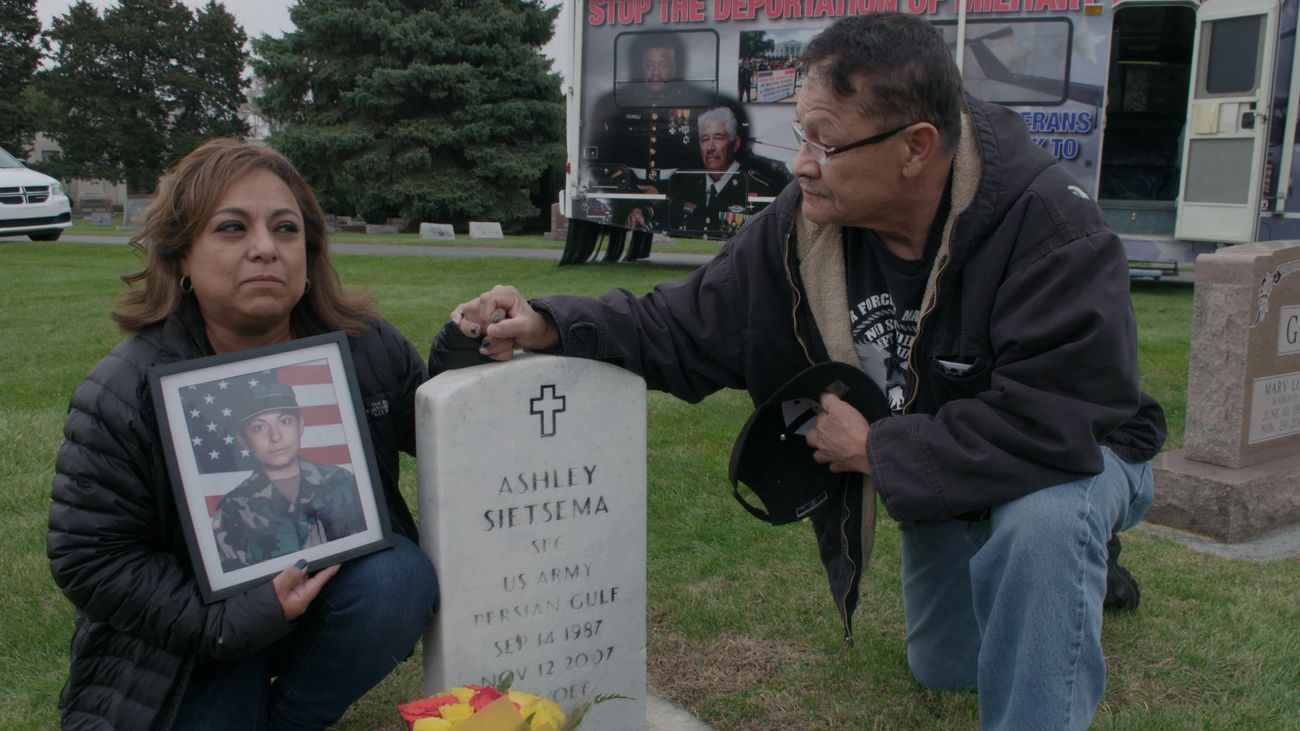 Olivia and Manuel remembering fallen daughter at grave stone