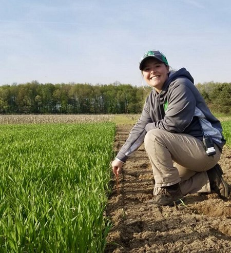 Samantha Thompson in a field of crops