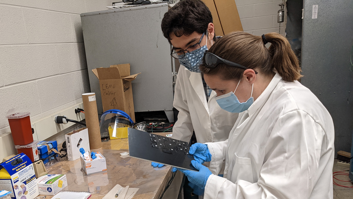 Kendall Mahn, MSU associate professor of physics and astronomy, works on a project at a workbench with Elias Taira, a Charles Drew Science Scholar.