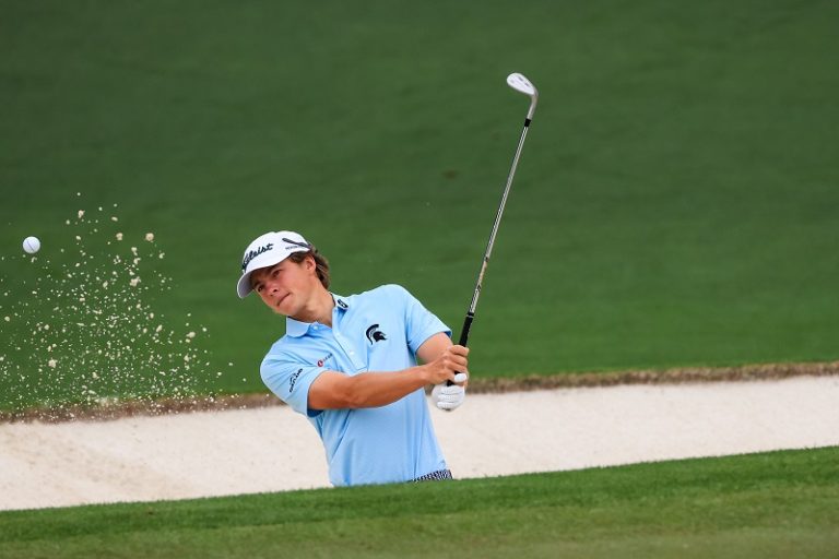 James Piot chips out of a sand bunker