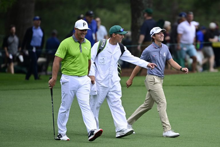James Piot walks the 17th fairway with Bryson DeChambeau at the 2022 Masters