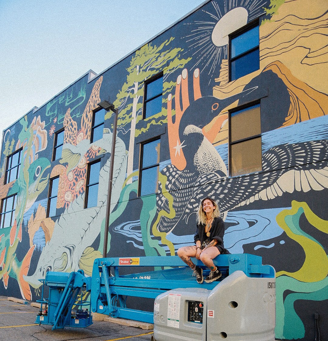 Maddison Chaffer in front of mural, titled