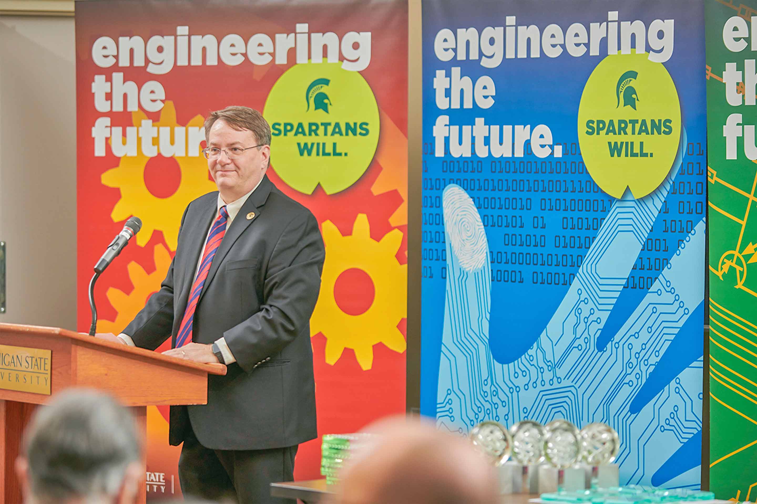 College of Engineering Dean Leo Kempel speaks at a podium during the college’s Design Day event. 