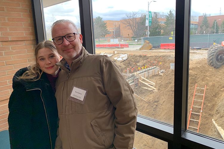 Lily Kirkman, packaging senior and president of CoPPAC, with her father, MSU alumnus Bob Kirkman, at the Packaging Building Groundbreaking Ceremony in April 2022. In the background, construction is taking place to renovate the School of Packaging building.