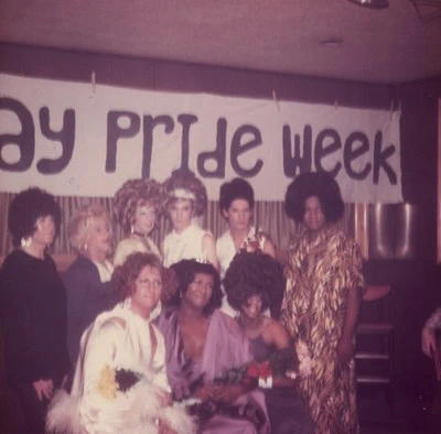 Drag queen contestants posing in a group at Joe Covello's bar in Lansing.