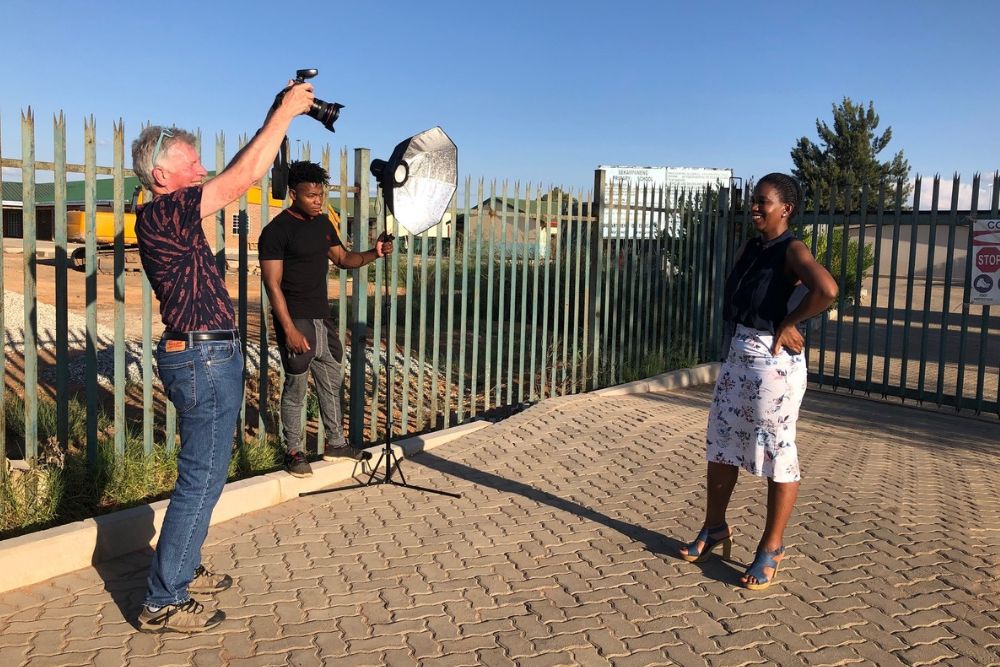 Professor Peter Glendinning (left) with a South African youth collaborator, Thapelo Modibane (center), photographing one of the Attached to the Soil subjects, Nkele Johanna Baloyi (right).