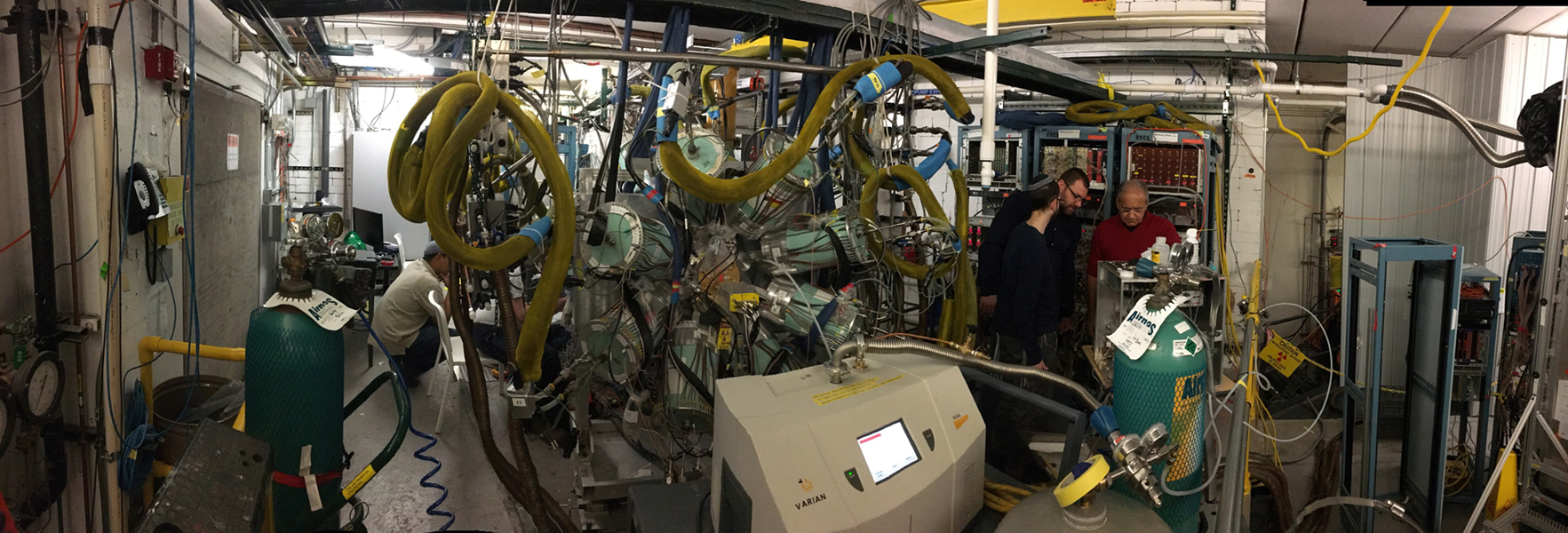 A panoramic photo shows the GADGET device in laboratory. It’s as tall as the room and about as wide.
