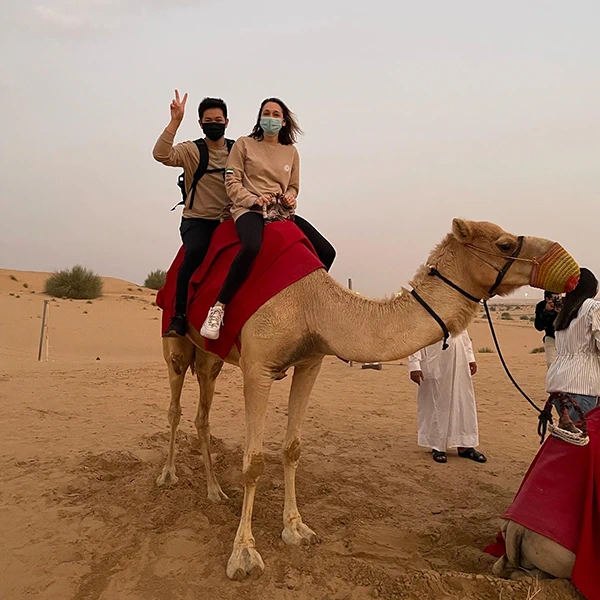 David and Megan Delong take a camel ride on their last day in the UAE.