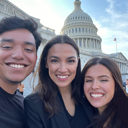 U.S. Representative Alexandria Ocasio-Cortez stands with JMC student Alexie Milukhin on the steps of the U.S. Capitol in Washington D.C.