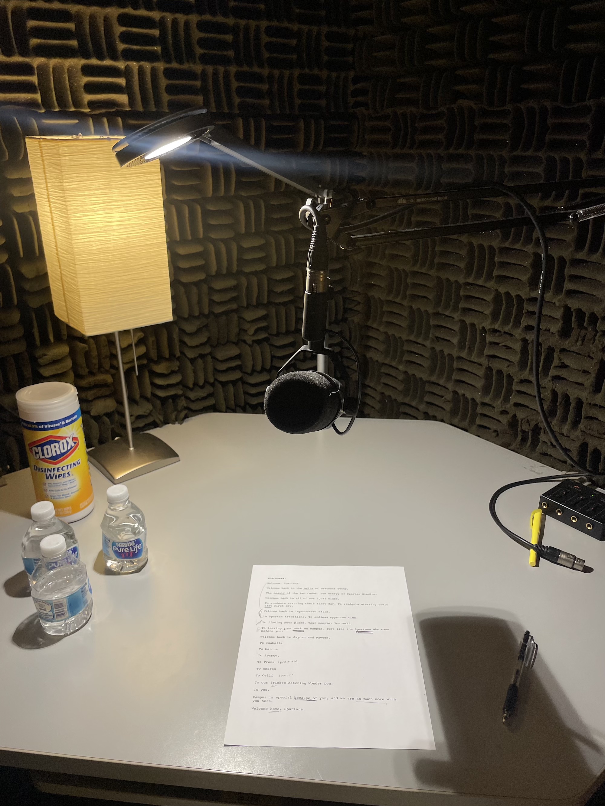 Microphone in recording studio with script below