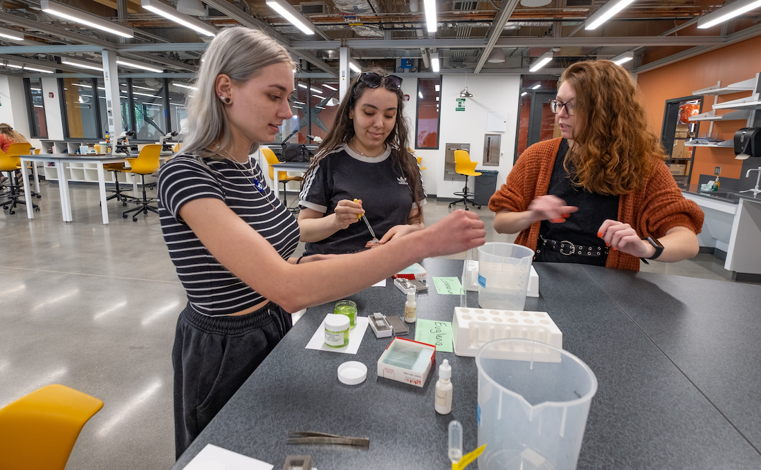 Three female students work together in a lab in MSU's STEM building. 