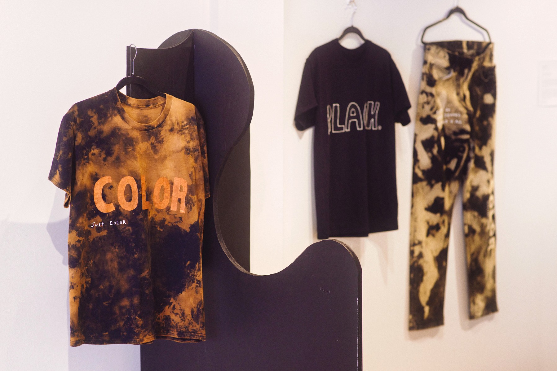 “FLESH” Collection 2.0 custom garments by Kamryn Whitfield that are part of the Black Jubilation exhibition. The garments are acid-washed and hand-painted.