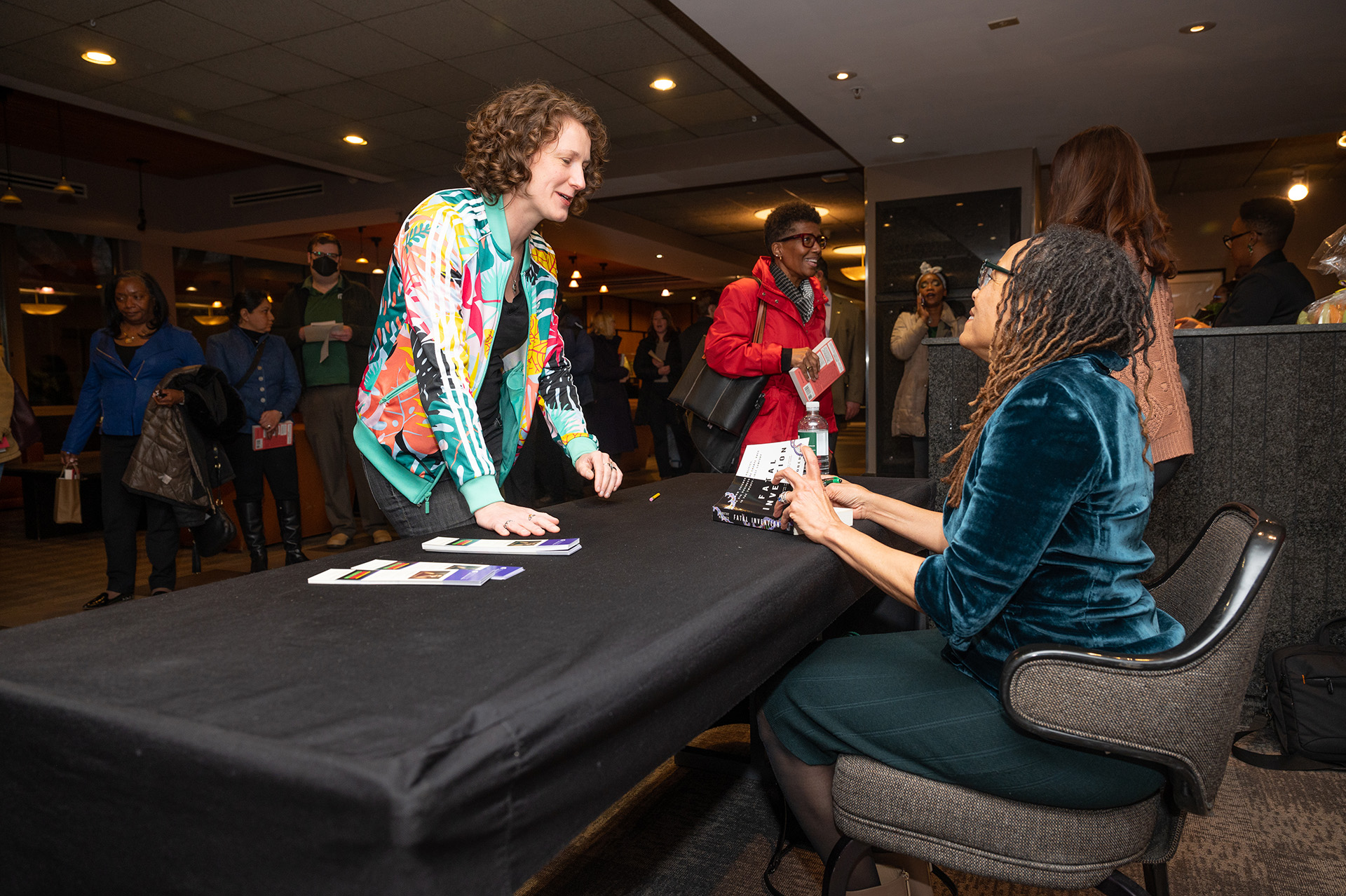 Dorothy Roberts signing books following the IDI Speaker Series event