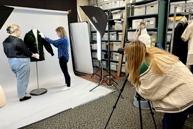 MSU students examine and photograph a piece of clothing in the MSU Museum’s apparel collection.