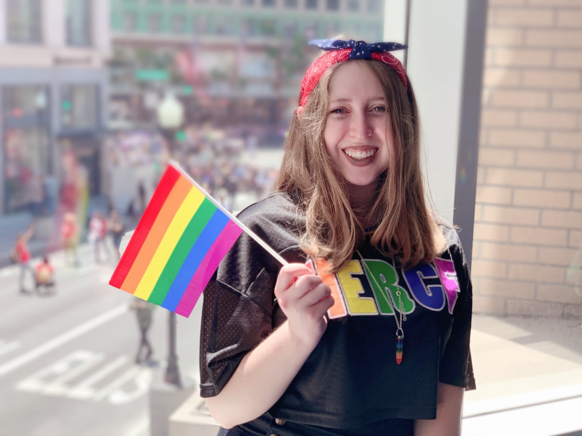 Angela Demas holding a pride flag at a march