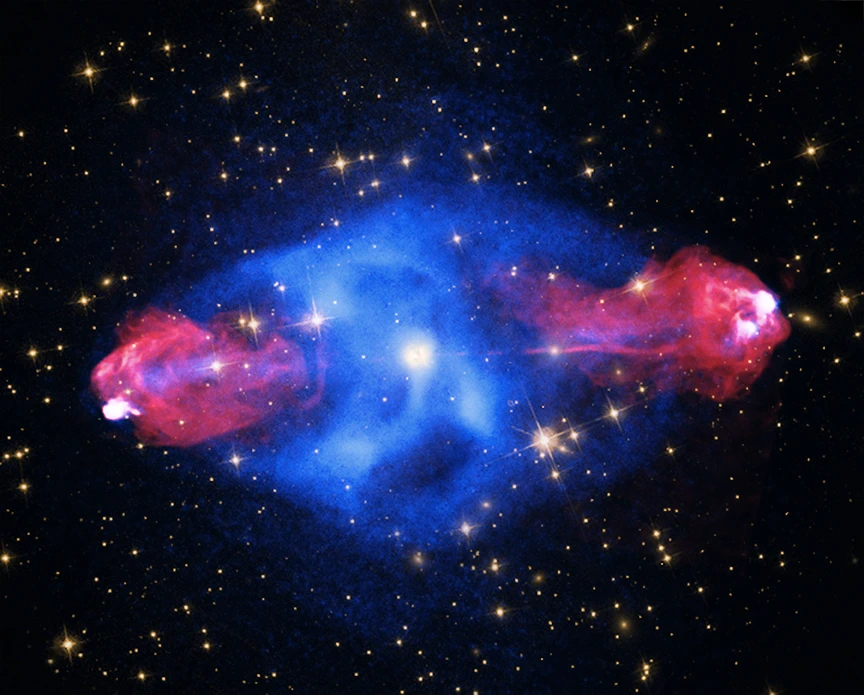 The galaxy Cygnus A is seen at the center of this image shrouded in plasma (shown as a concentrated blue mass) with high-energy jets (shown in red toward the outside of the plasma) shooting from the galaxy’s central black hole.