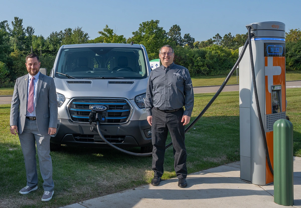 Judd Herzer and Jeff Myrom after plugging their vehicles into the new fast-charging station.