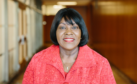the visit new update Patricia Edwards, wearing a red blazer