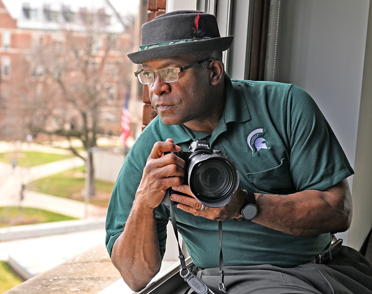 Derrick Turner with a camera in Olds Hall. Photo by G.L. Kohuth