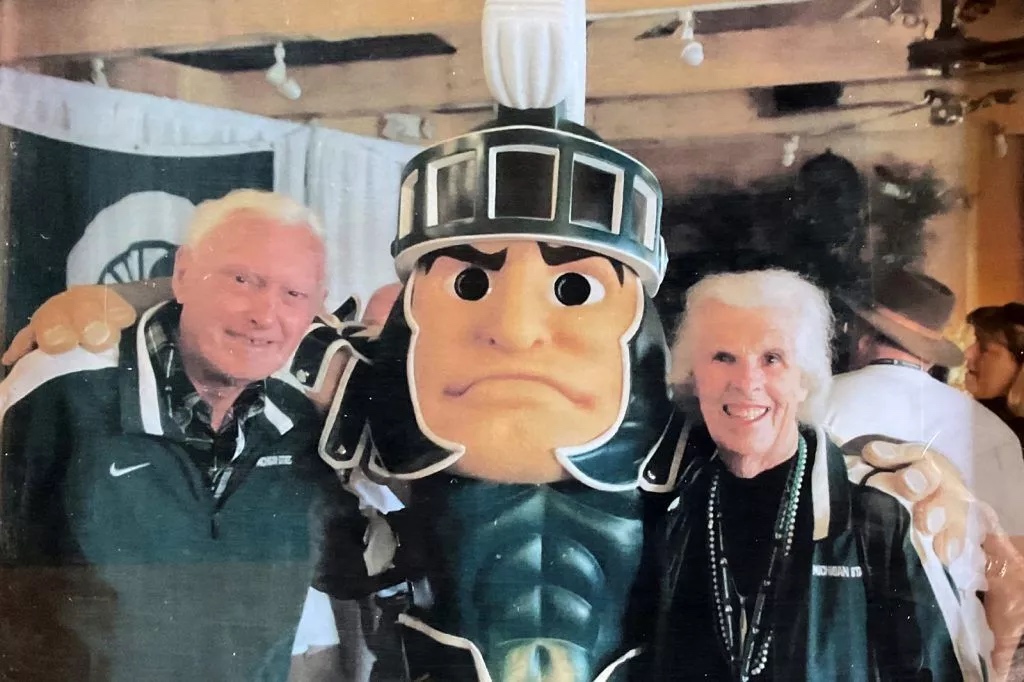 James and Claudia Prescott post with Sparty at the MSU event