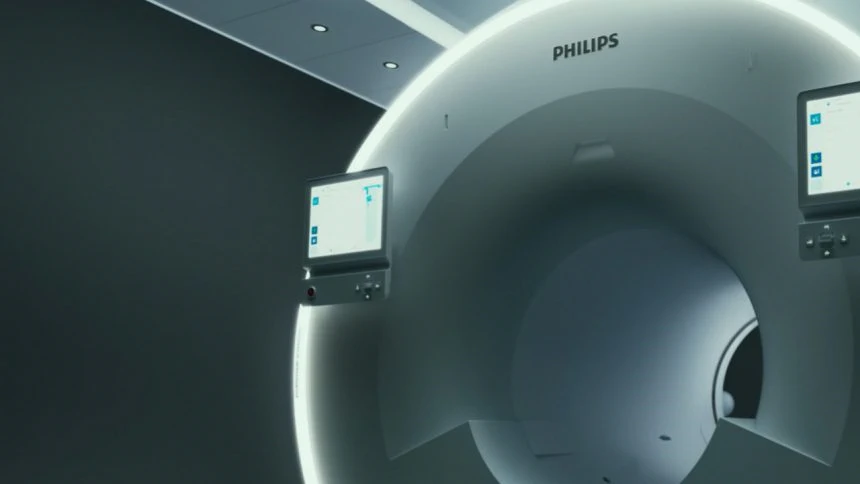 Philips MR 7700 MRI machine. A large circlular vessel with two computer screens. 