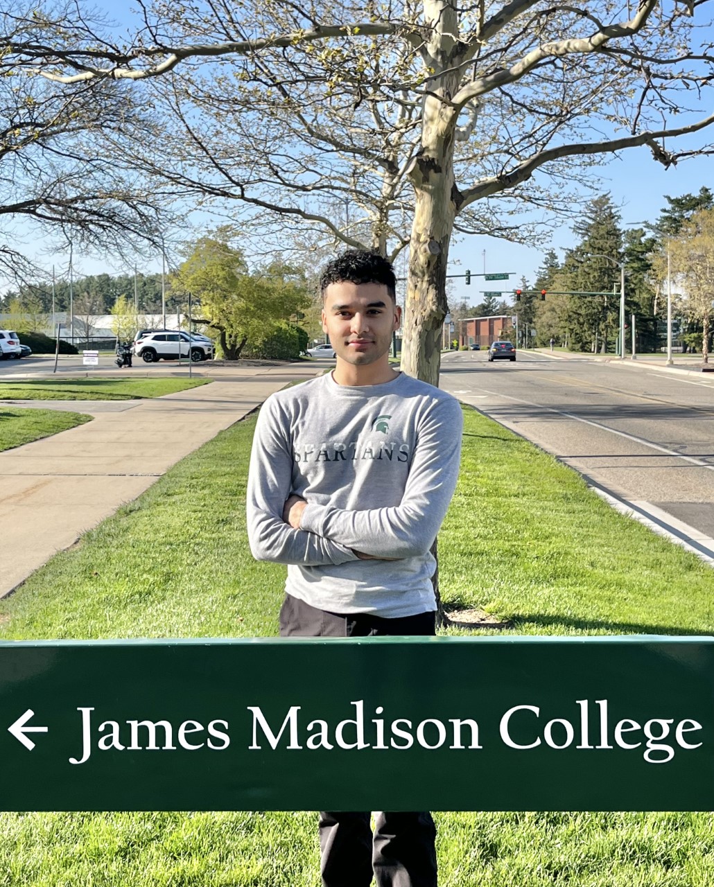 Emilio Silerio Gonzalez behind James Madison College sign