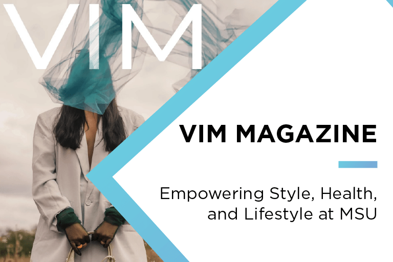 An image of a person in a tan jacket with a teal piece of fabric of their face, flying in the wind. On the image it says VIM: Vim Magazine Empowering Style, Health, And Lifestyle at MSU.