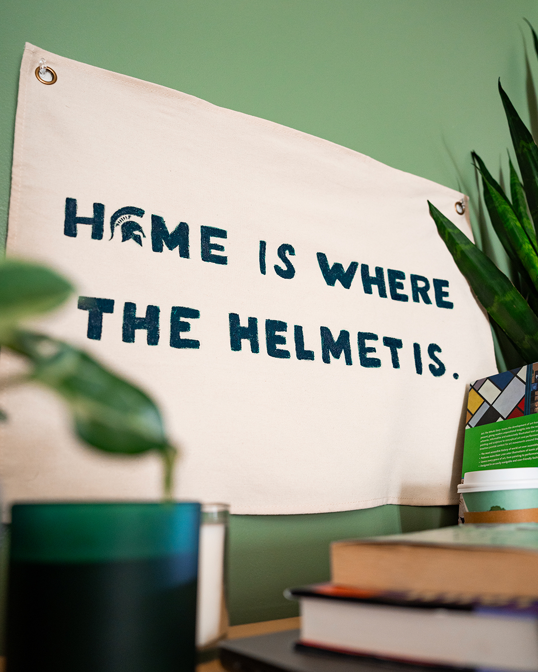 Canvas flag that reads: home is where the helmet is