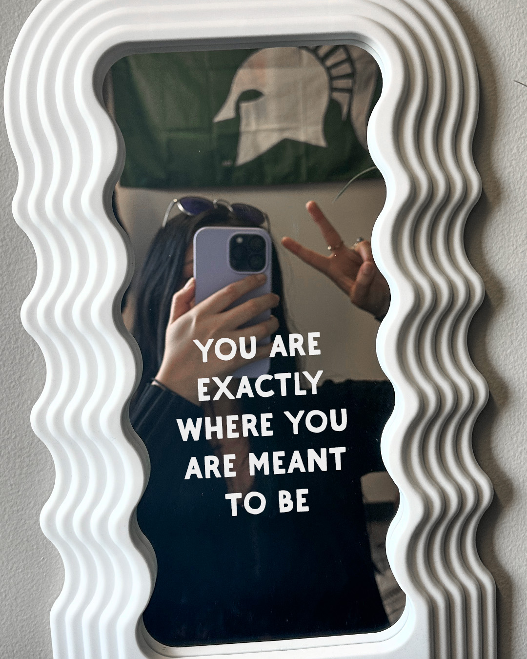 Mirror with writing on it that reads 