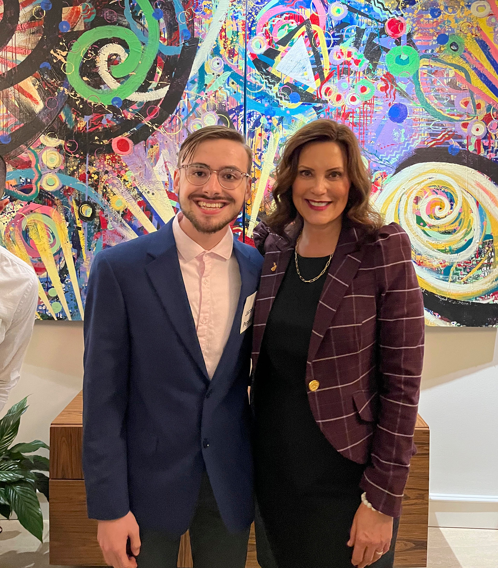 Jacob Pepper and Gov. Gretchen Whitmer standing in front of a painting.