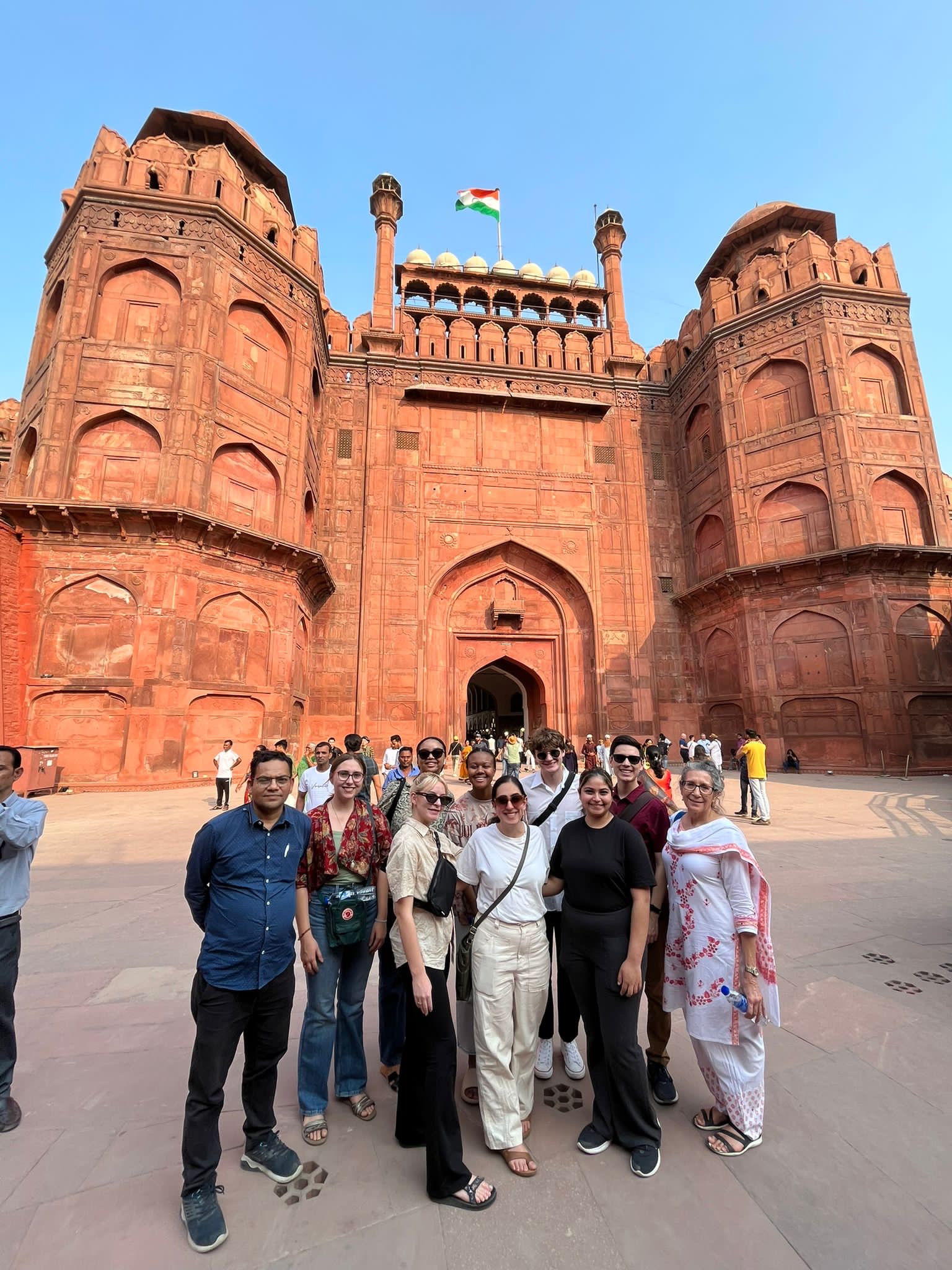 A colleague from PRIA and students and faculty from JMC stand in front of the entrance to the Red Fort in Delhi.