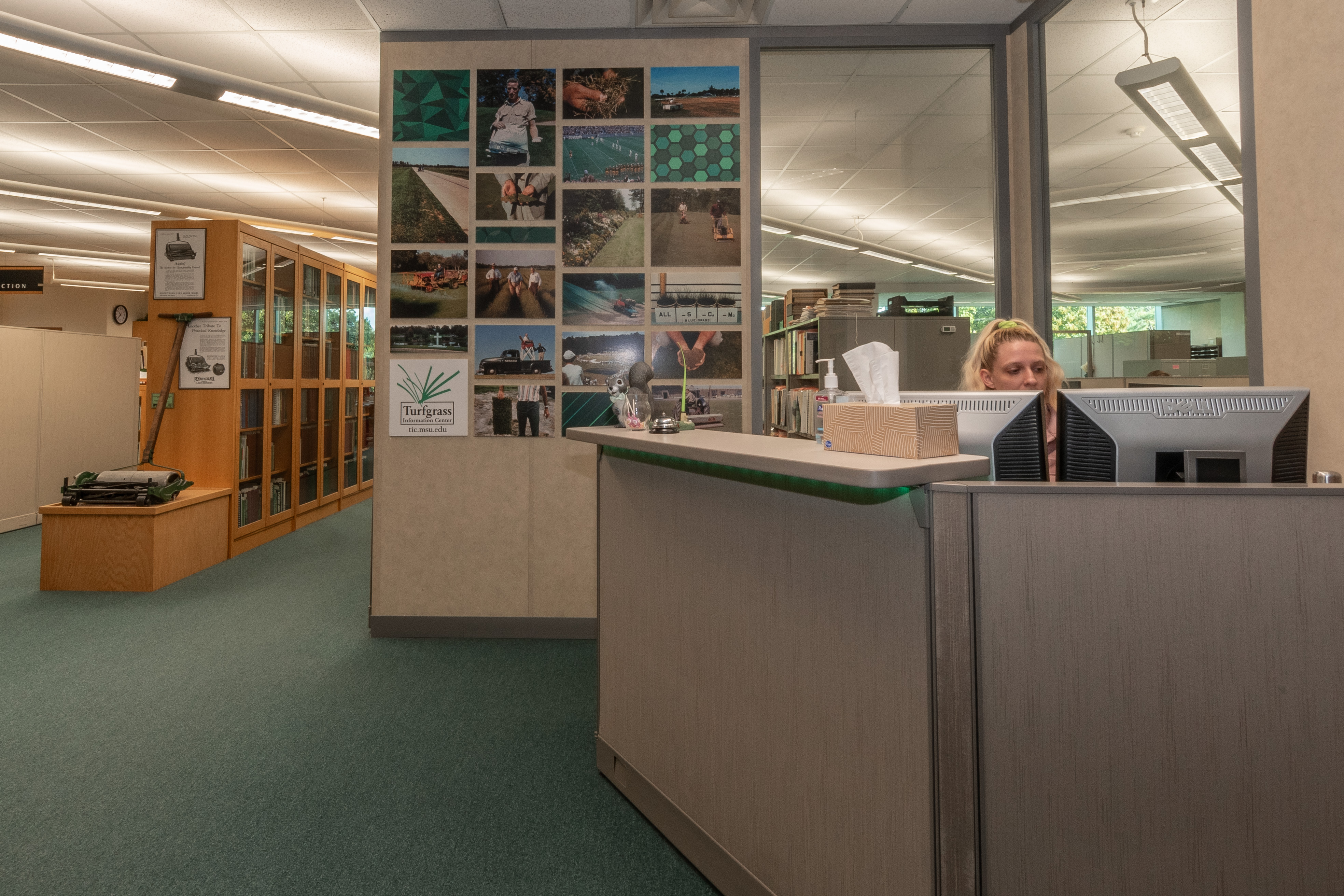 Head of the Turfgrass Information Center Elisabeth Mabie behind the Turfgrass Information Center help desk.