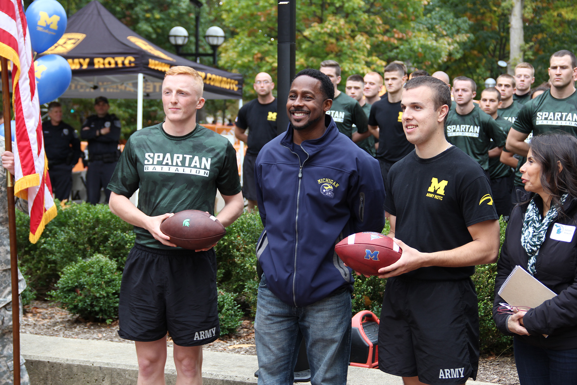 cadets from MSU and U-M prepare to hand the game day football over