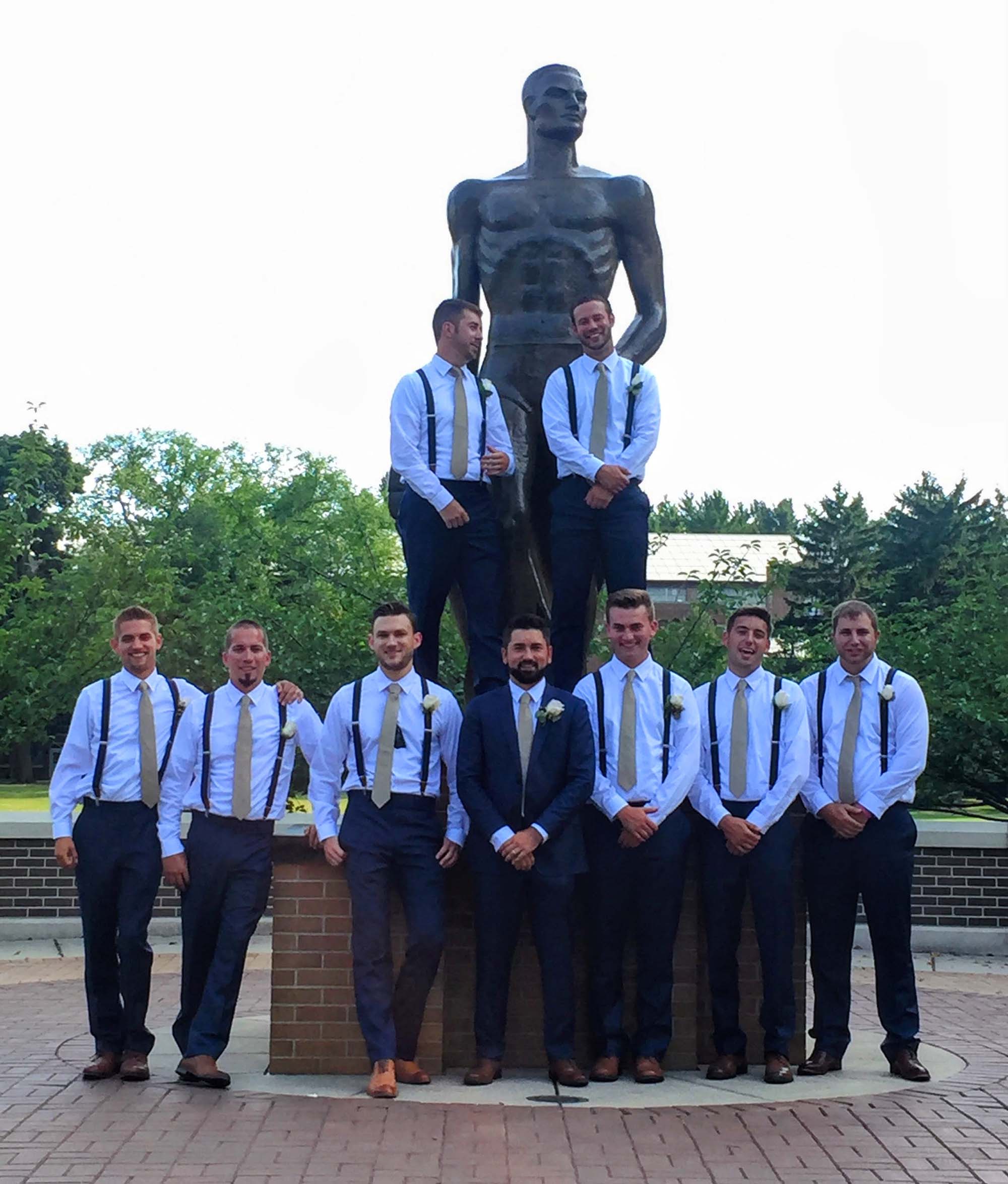 Group of groomsmen with the Spartan statue
