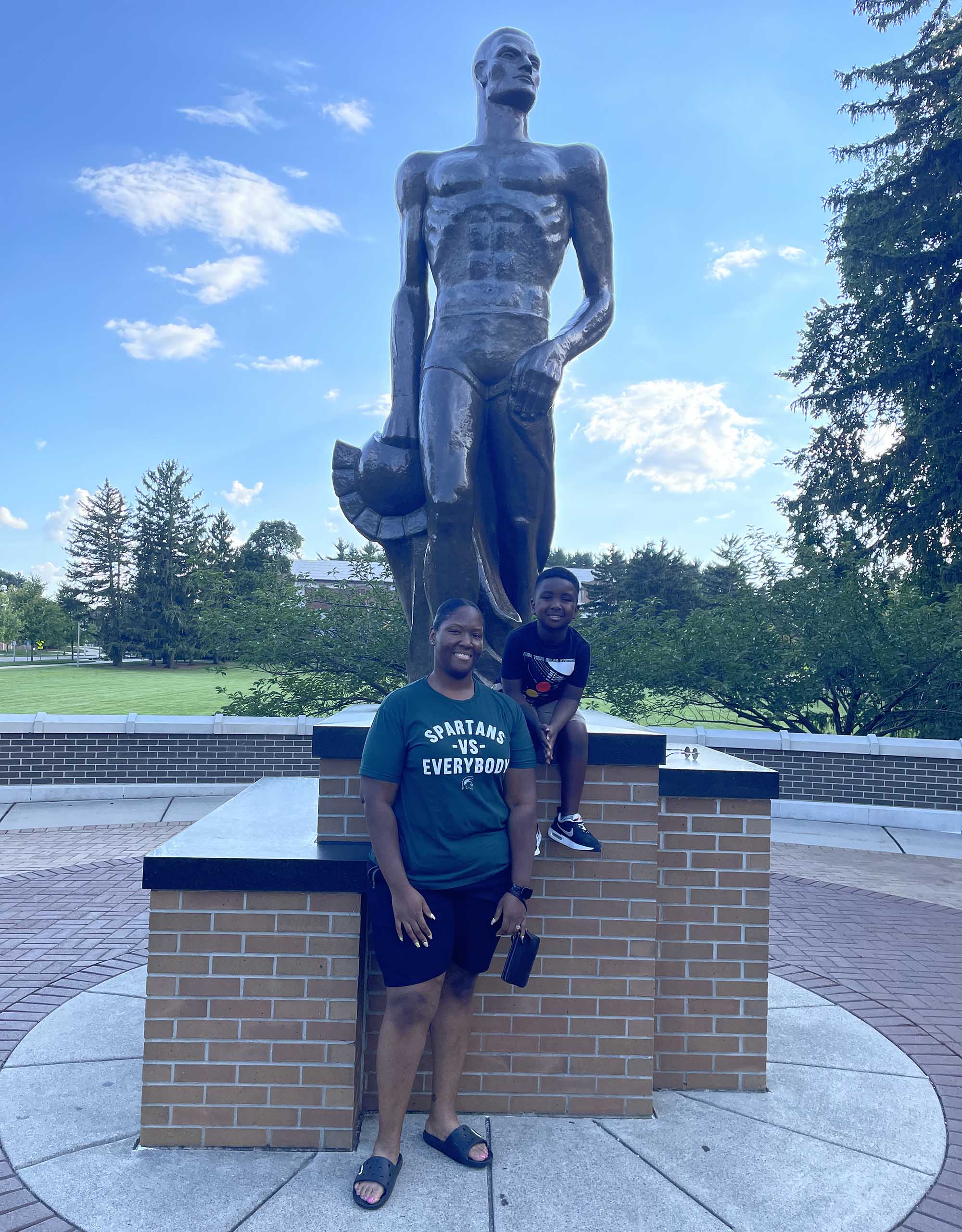 Dequindre Williamson and son in front of Spartan Statue