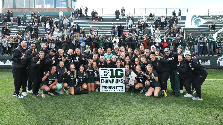 The Michigan State women's soccer team poses with a sign that reads B1G Champions