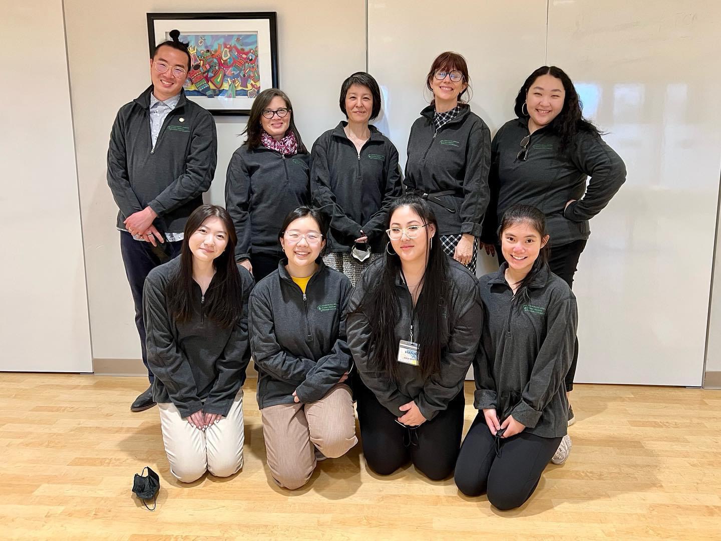 APA Studies leaders and students pose for a photo wearing matching grey shirts