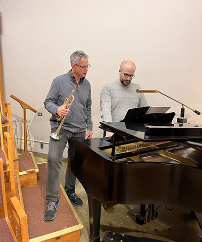 Trumpeter Neil Mueller (left) rehearses David Biedenbender’s River of Time with the composer.