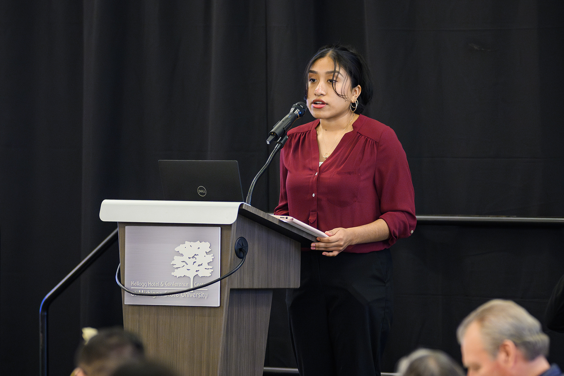 A students speaks at the celebration at the podium