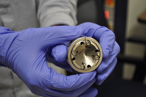 Xie Group graduate student Haozhe Wang holds a diamond anvil cell, or DAC. Using two perfectly matched diamonds, the high-pressure instrument allows researchers to exert immense force on their chosen sample. Credit: Connor Yeck