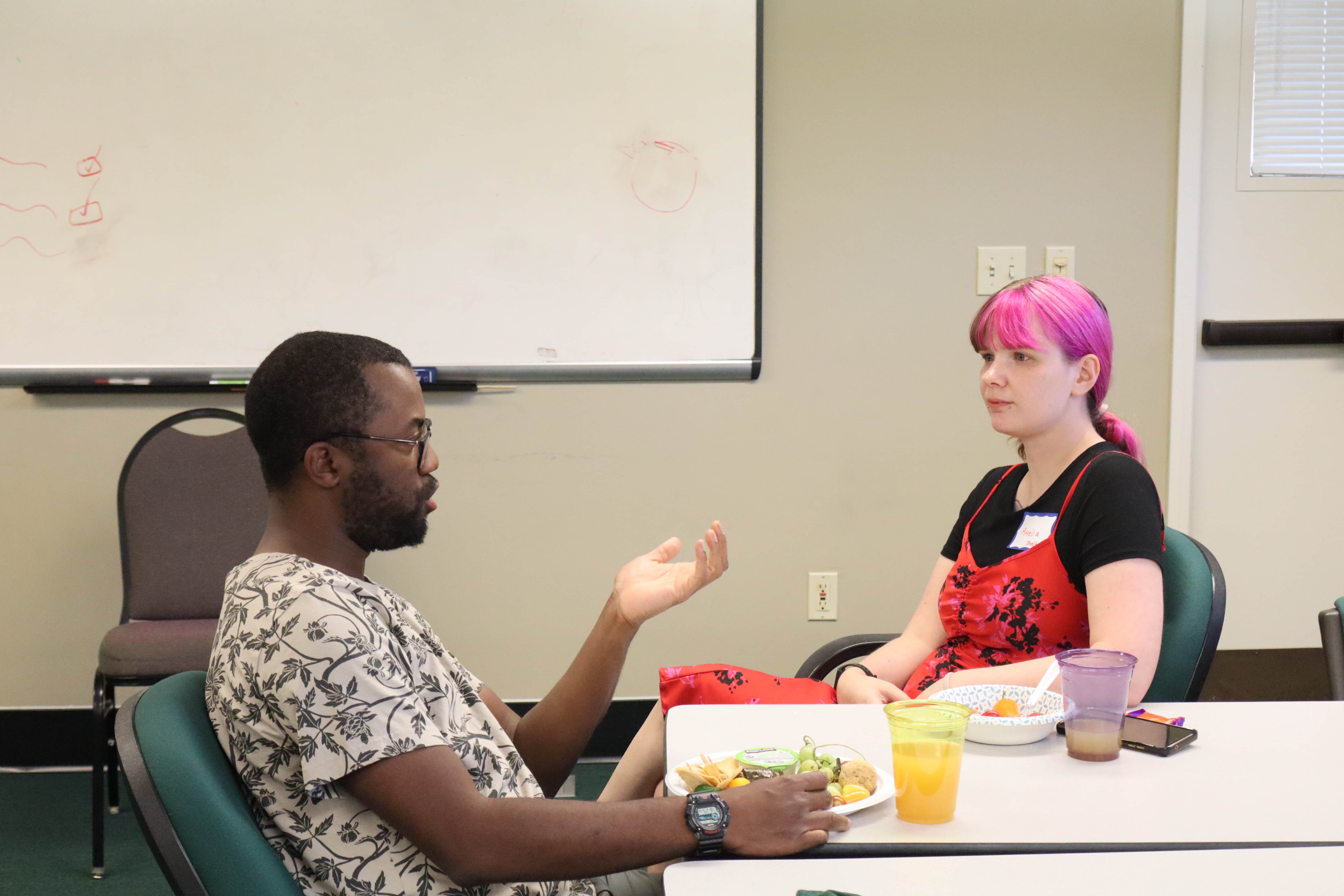 EEB core faculty member Kadeem Gilbert chats with an Envision EEB Weekend attendee.