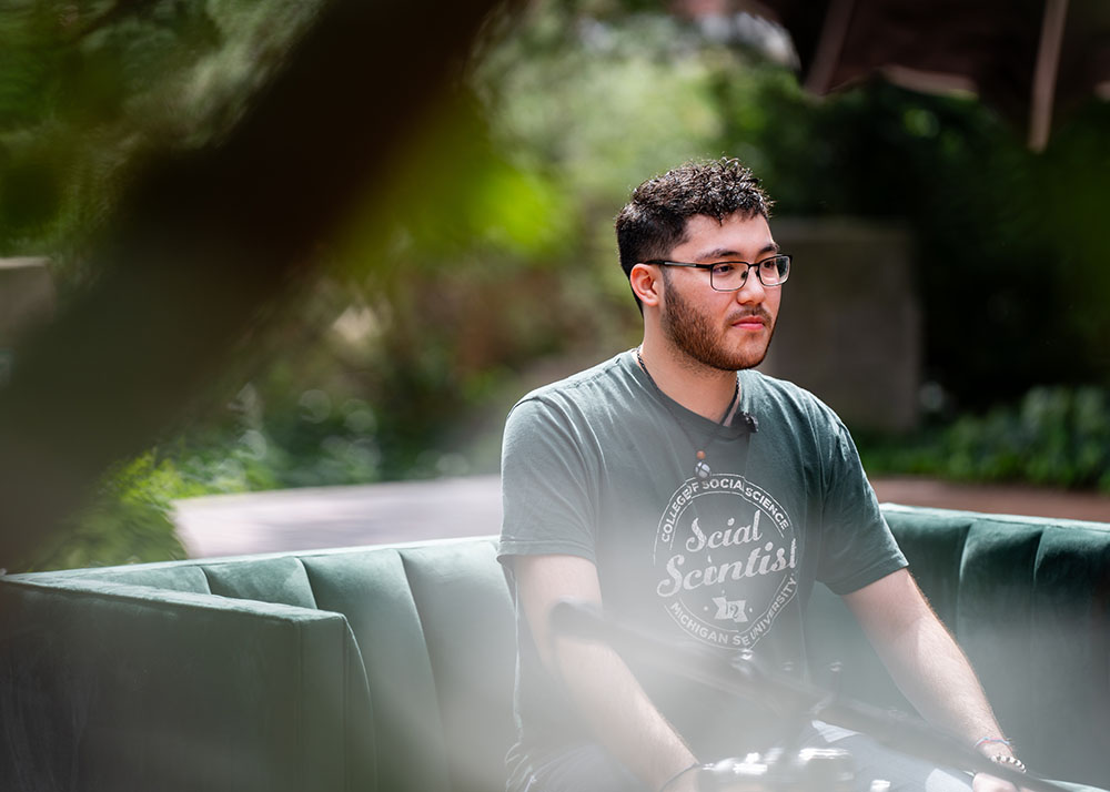 Person sitting on green couch