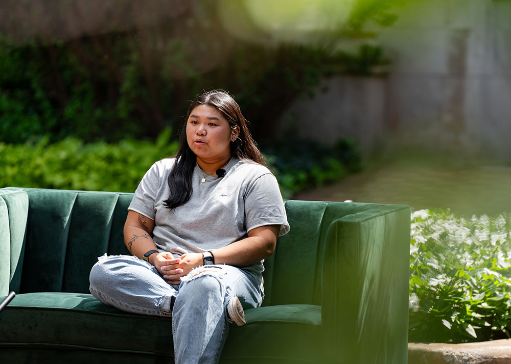 Person sitting on green couch